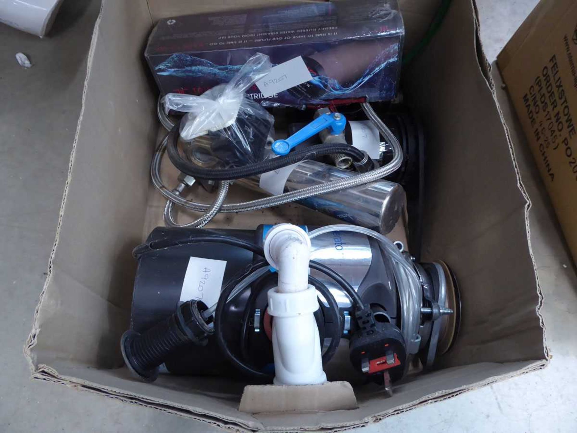 Box containing a macerator and other plumbing items