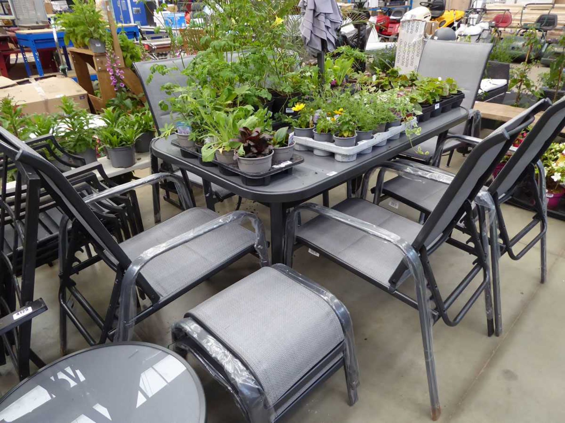 Rectangular metal framed glass topped table with 6 chairs, small round side table and 2 footstools