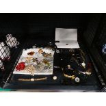 Cage containing costume jewellery and wristwatches