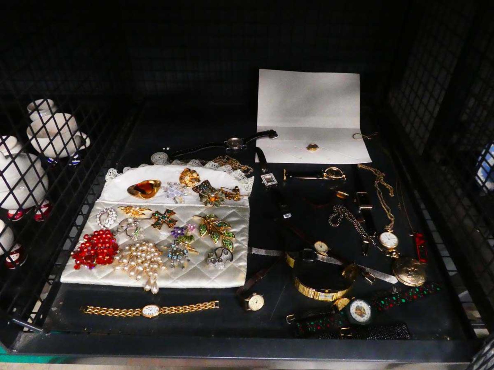 Cage containing costume jewellery and wristwatches