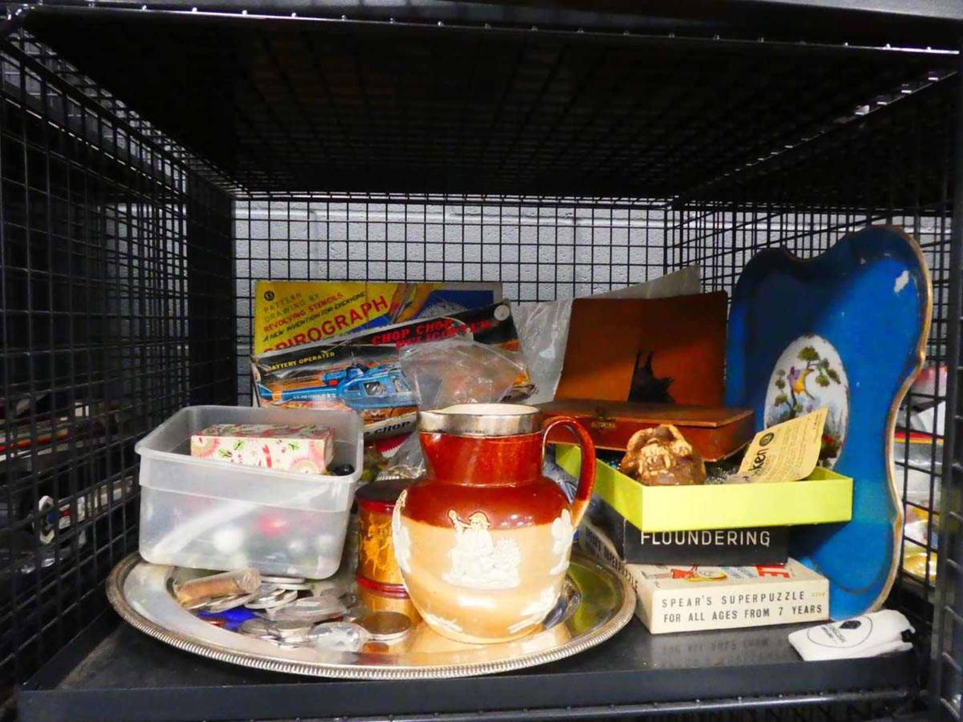 Cage containing harvest jug, coinage, marbles, children's toys and dress jewellery