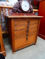 Small oak chest of four drawers with a fall front panel under