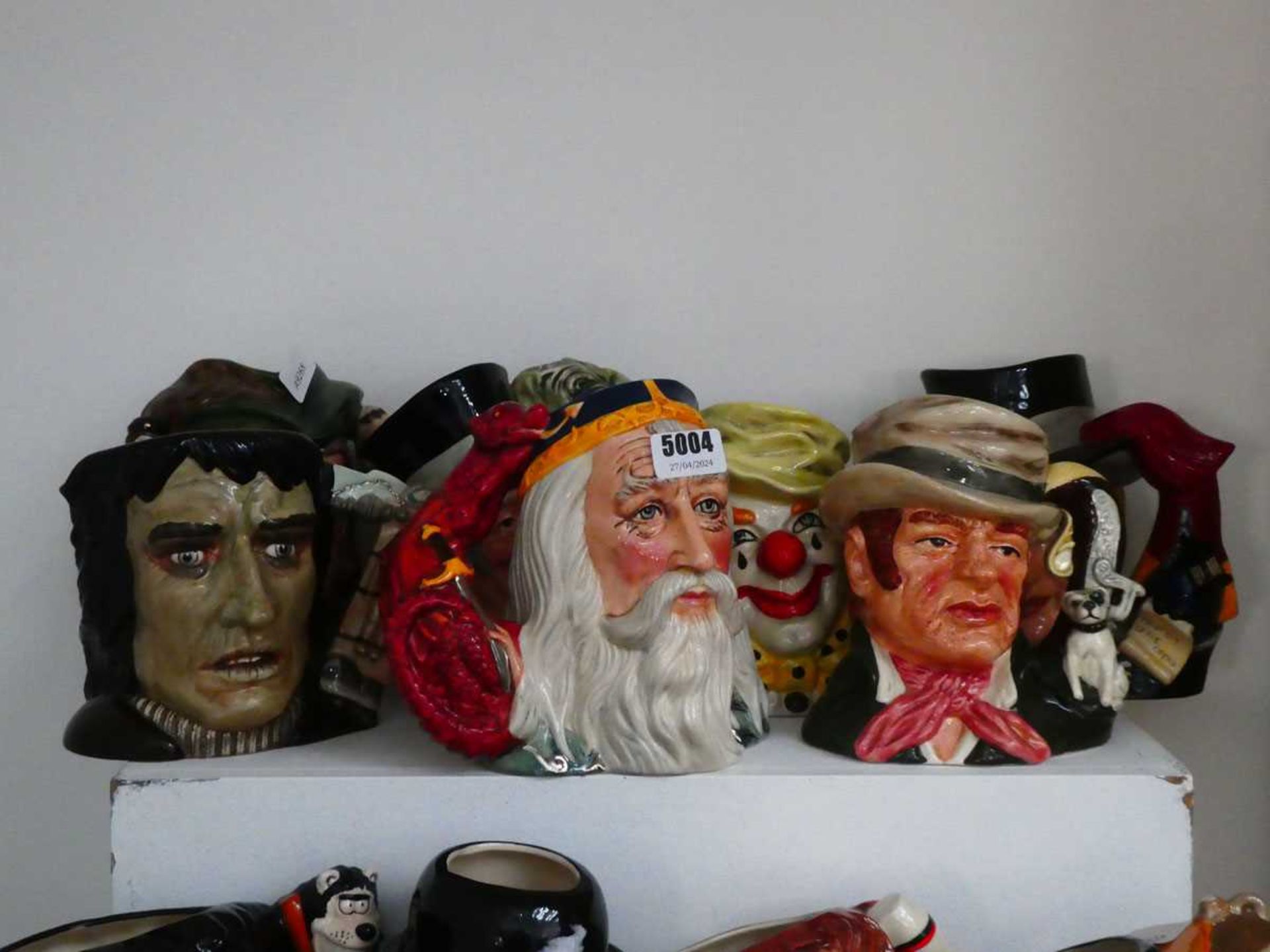 7 large character jugs depicting fictional characters, to include Phantom of the Opera, Bill