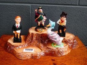 Royal Doulton stand with 4 figures to include Jemima Puddle-Duck, Oliver Twist and others