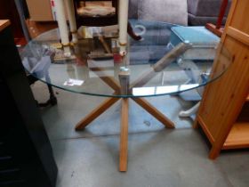 Circular glazed dining table with oak supports