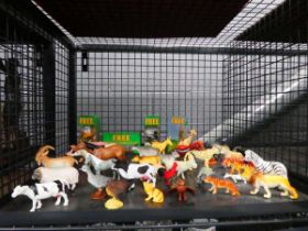 Cage containing plastic farmyard and wild animals