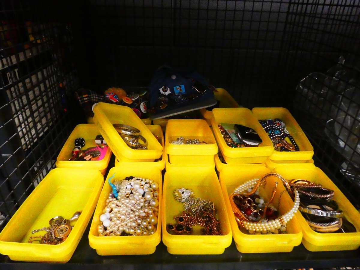 Cage containing costume jewellery and pin badges