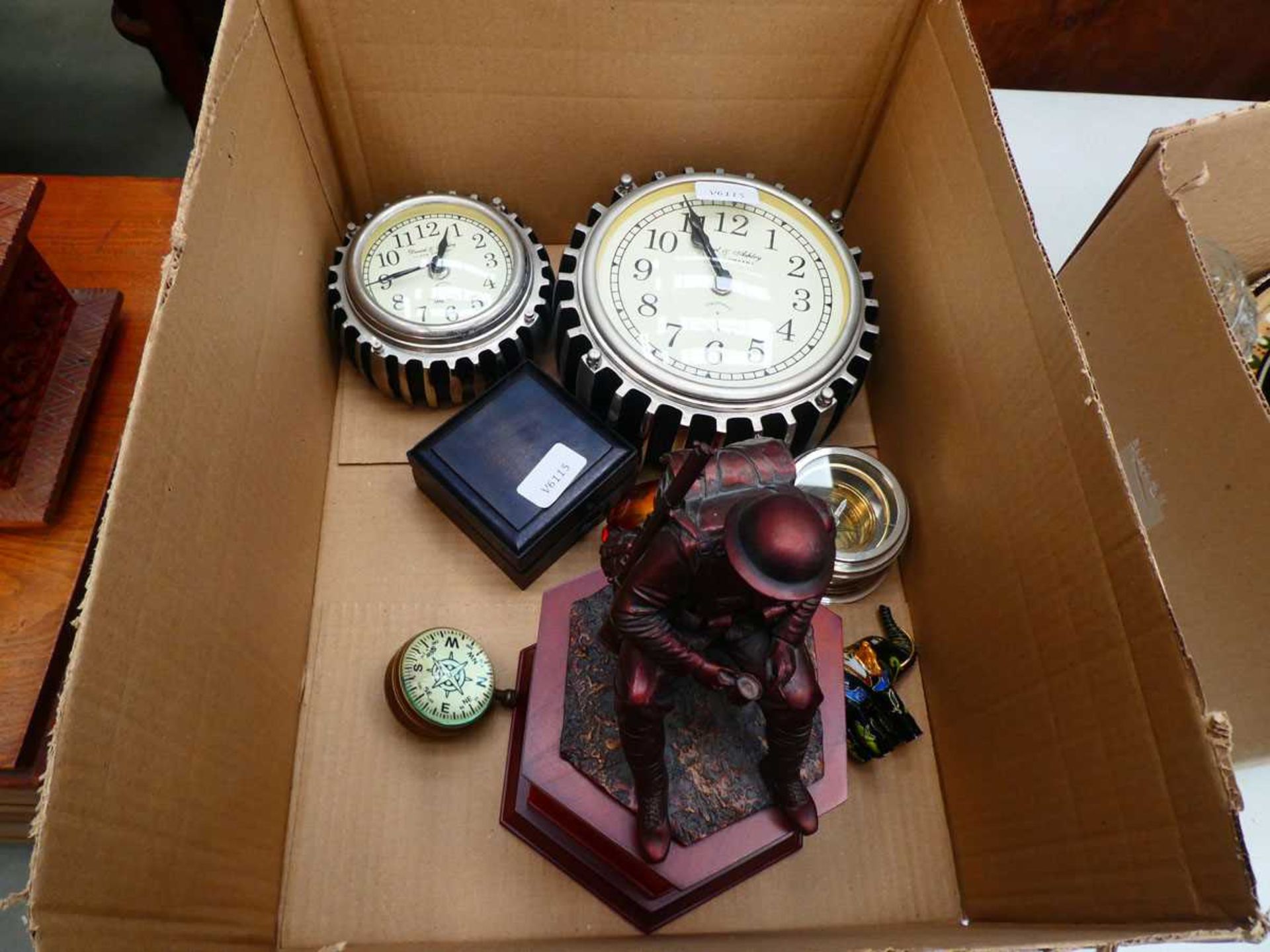 Two cog shaped quartz clocks with figure of an infantryman, a ball watch, elephant figures and