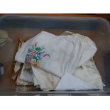 Box containing vintage doilies and tablecloths