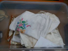 Box containing vintage doilies and tablecloths