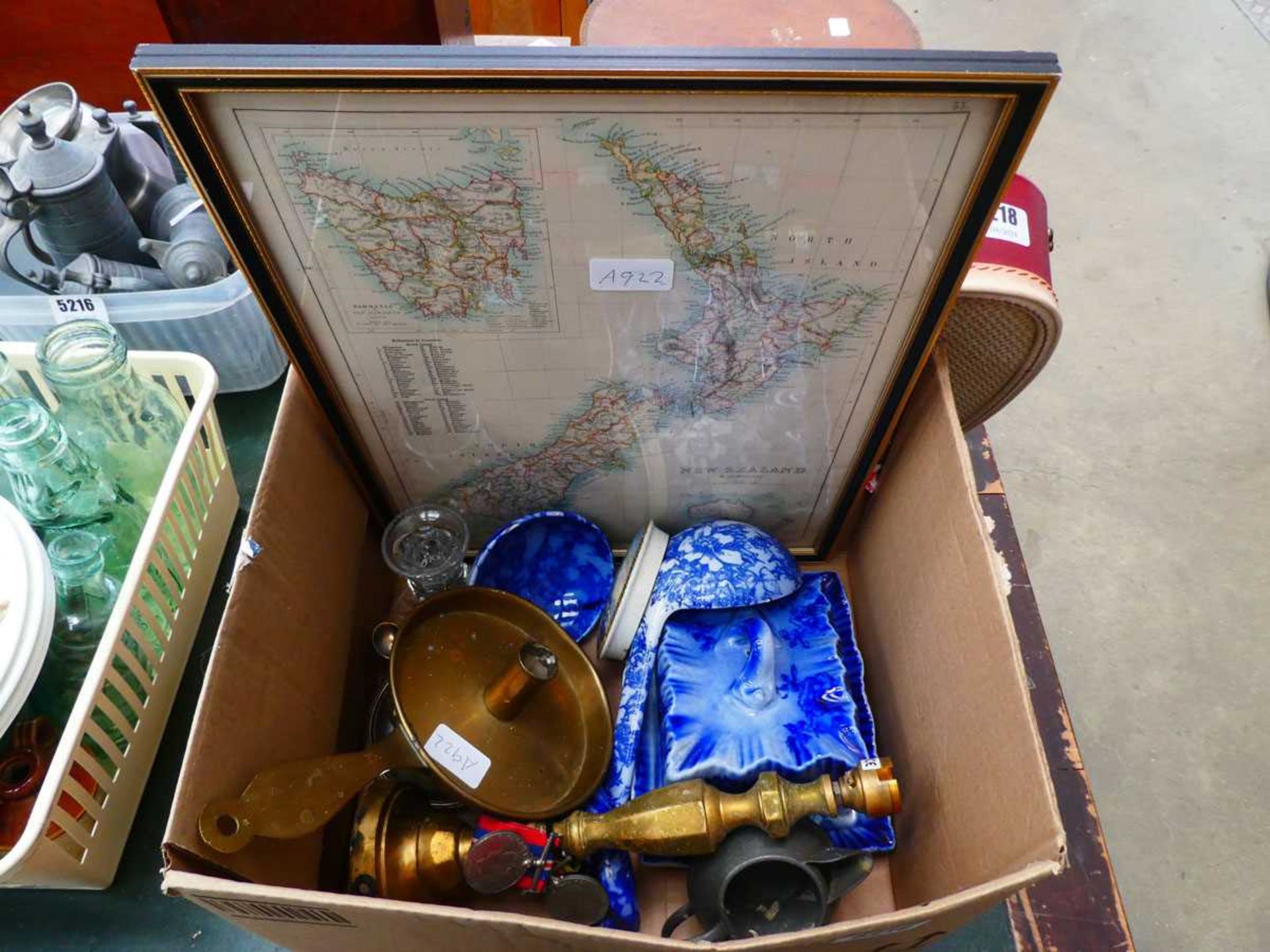 Box containing a map of New Zealand, military medals, brass candlestick, table lamp, blue and