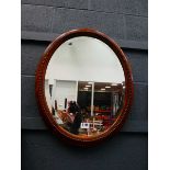 Oval bevelled mirror in oak frame