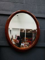 Oval bevelled mirror in oak frame