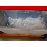 Plastic tub with quantity of champagne flutes and other glasses
