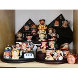 Various miniature Character Jugs on wooden stand