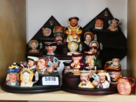 Various miniature Character Jugs on wooden stand