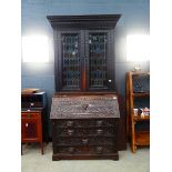 Heavily carved oak bureau bookcase with glazed and leaded door panels Approx. dimensions: depth 20