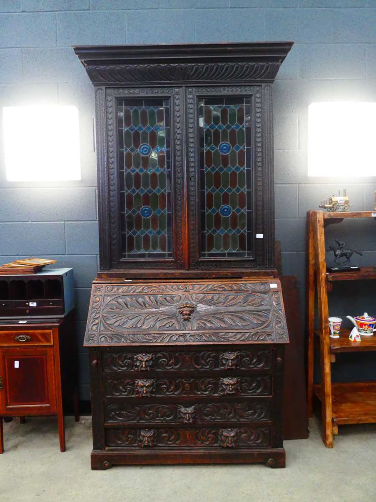 Heavily carved oak bureau bookcase with glazed and leaded door panels Approx. dimensions: depth 20