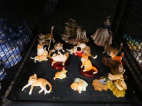 Cage containing resin cat figures