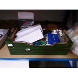 Box containing various items including laser toner cartridges, Nikon Lens trading cards, screen