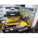 Box containing various remote control cars and games