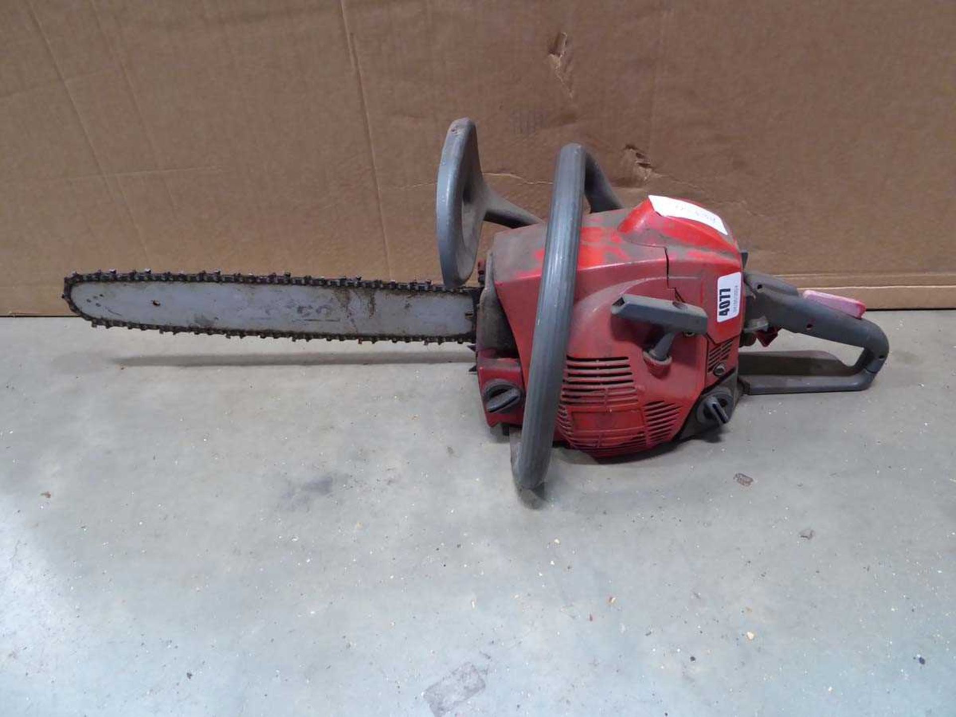 Red petrol powered chainsaw