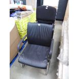 4 black cloth stacking chairs and black slide frame chair