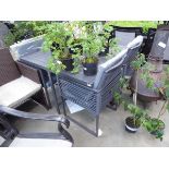 Square metal garden table with four string fold under chairs