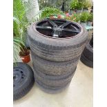 Four black alloy wheels and tyres