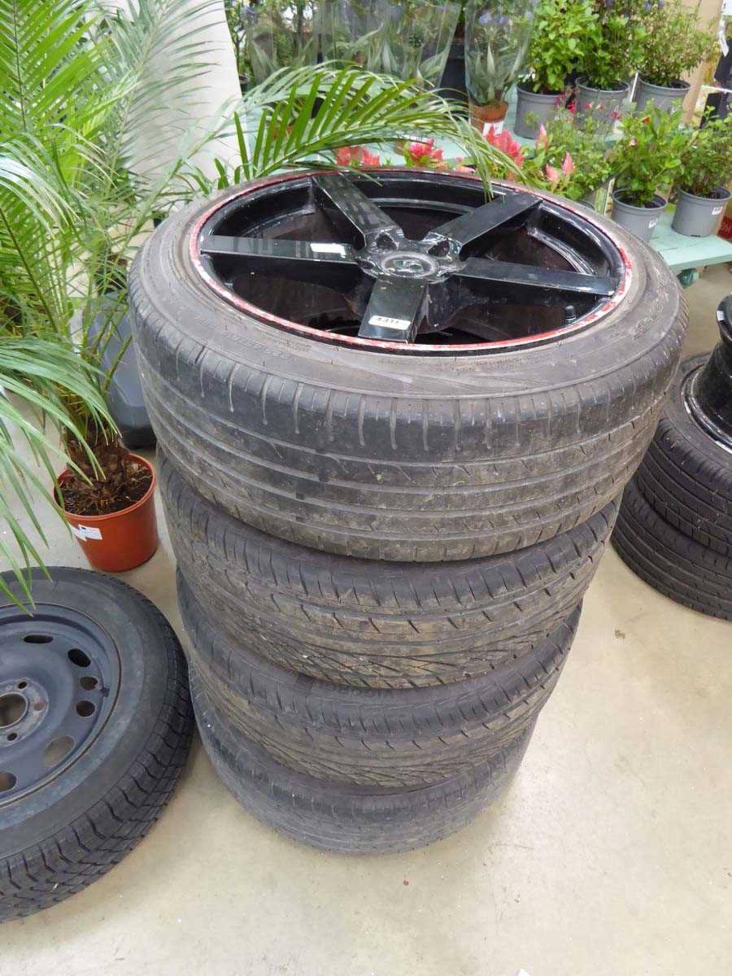 Four black alloy wheels and tyres