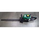 Green petrol powered hedge cutter