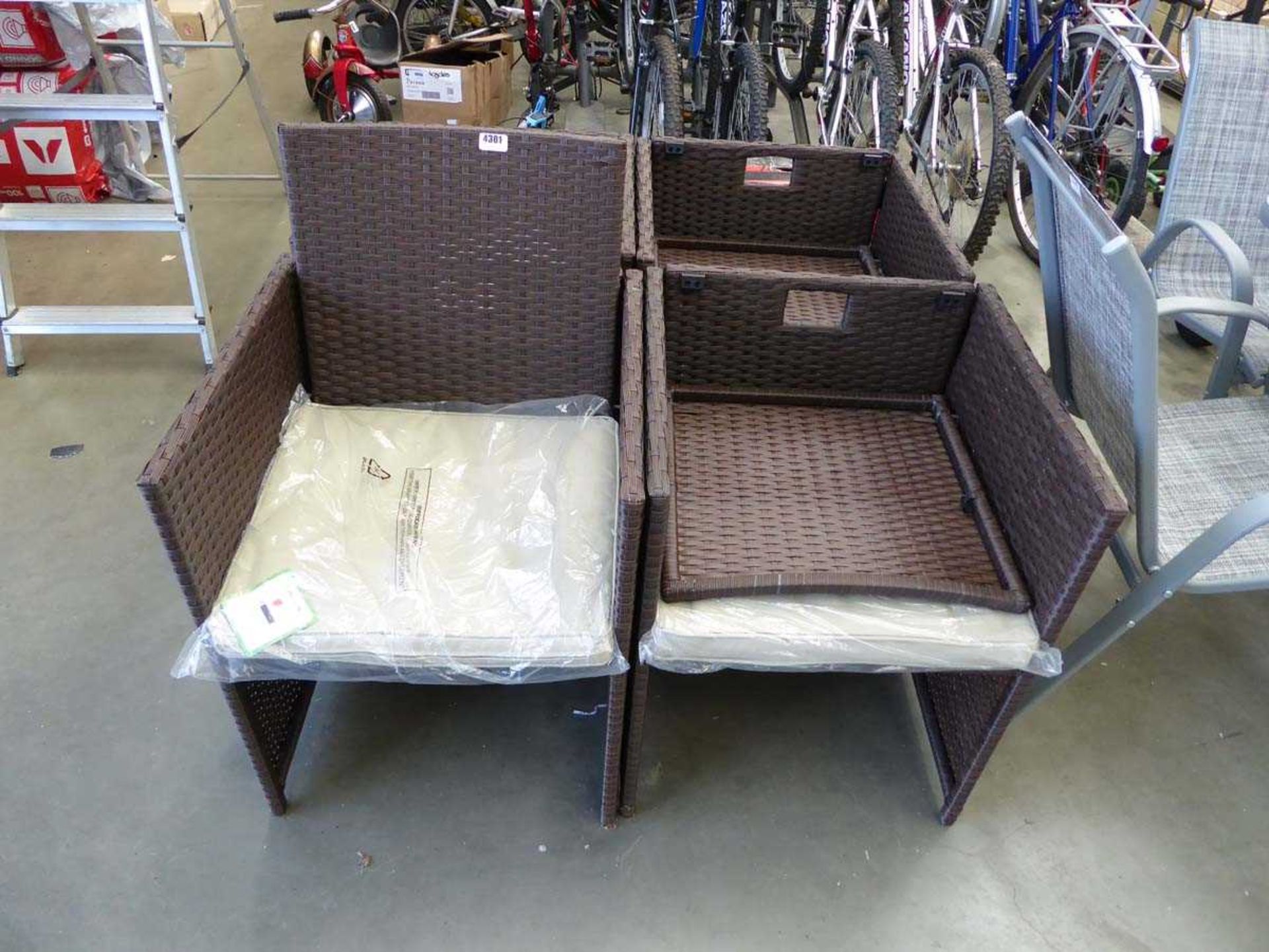 Four brown rattan garden chairs