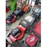 Red petrol powered rotary mower with grass box
