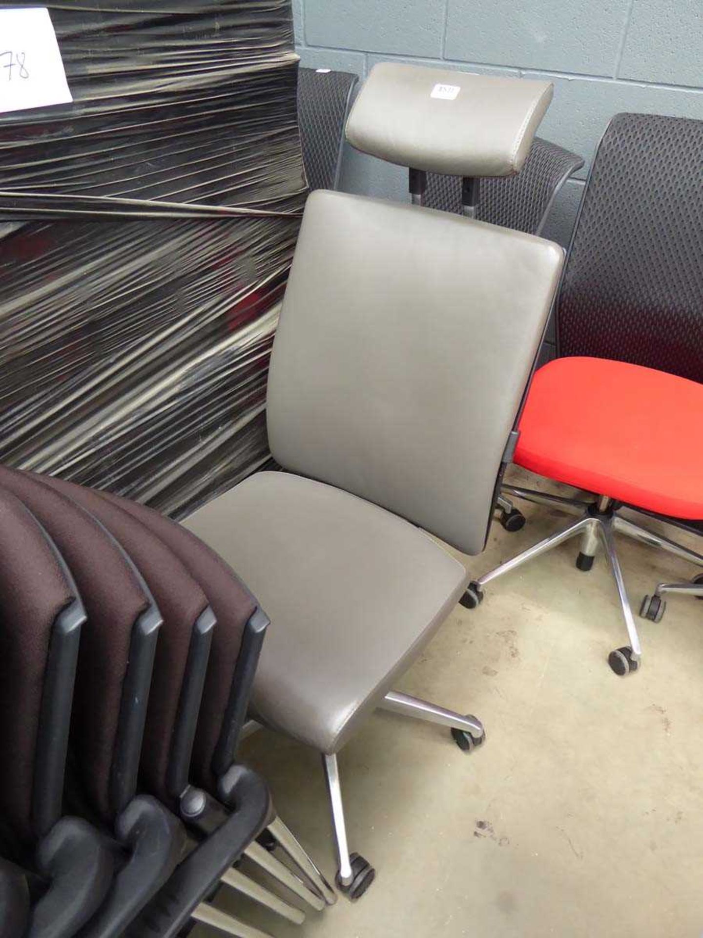 Grey highback swivel chair with headrest