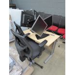 Small computer desk, 2 black cloth mesh back swivel chairs, and 4 computer screens