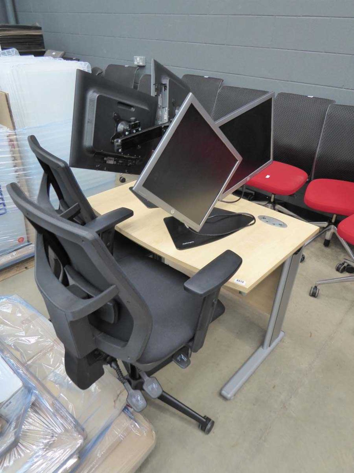 Small computer desk, 2 black cloth mesh back swivel chairs, and 4 computer screens