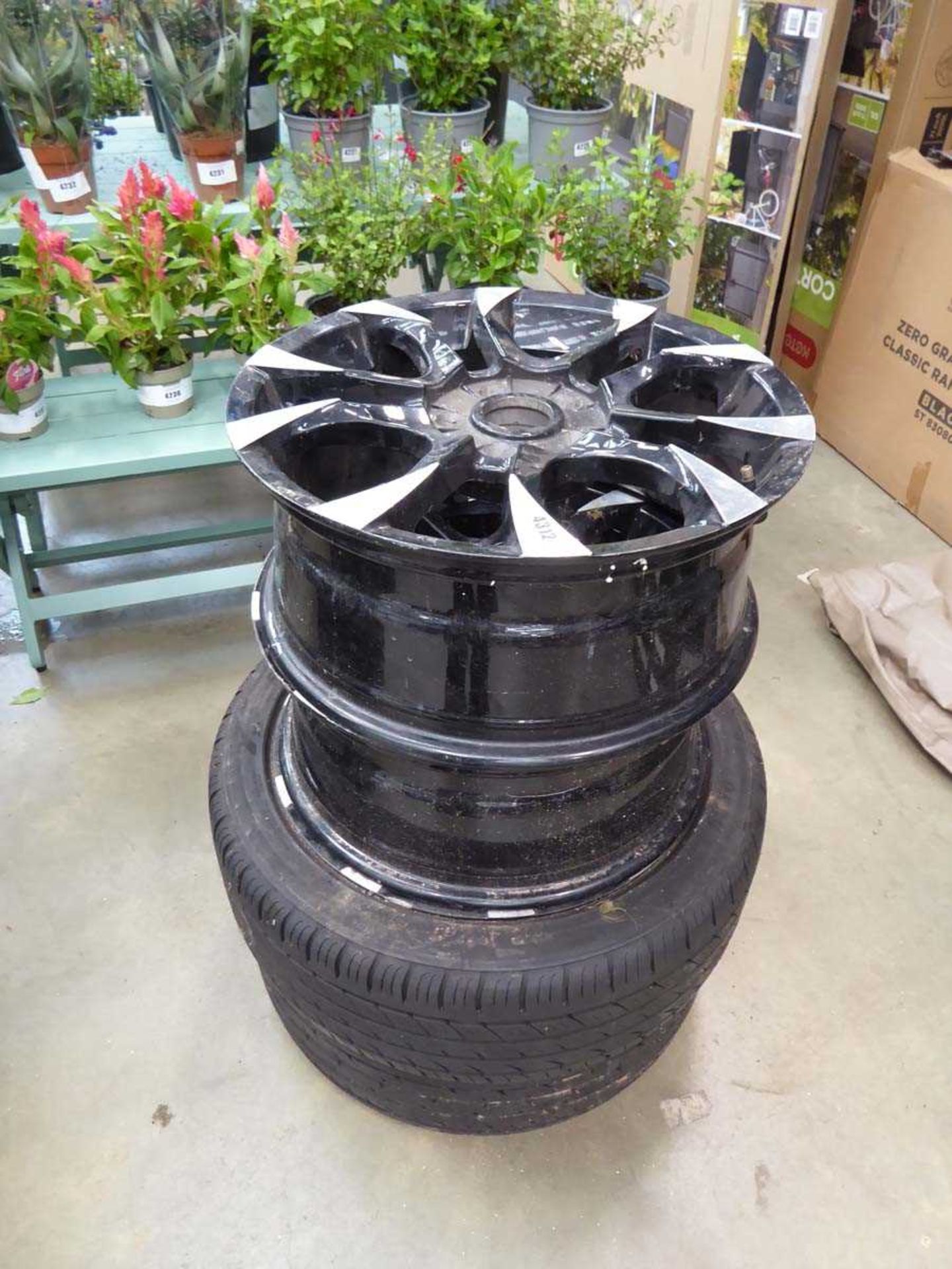 Four black and silver alloy wheels and two tyres