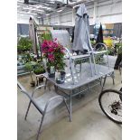 Grey rectangular glass topped metal frame garden table with 6 grey chairs and parasol