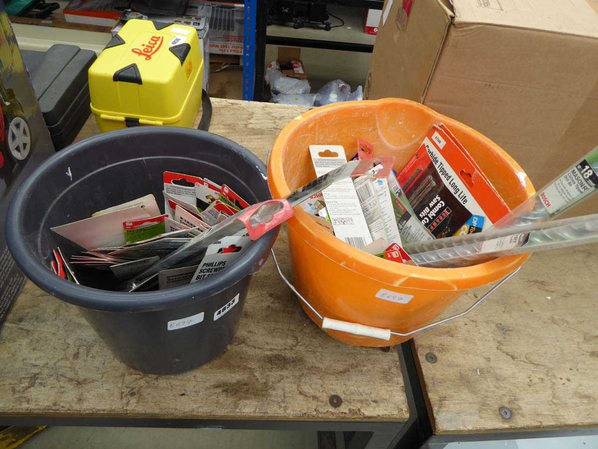 2 buckets containing screwdriver bits, drill bits, tile cutters etc