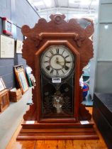 Waterbury Clock Company mantel clock in carved wooden case