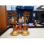 Quantity of copper and brassware to include a miniature still, kettle, plus a pair of candlesticks