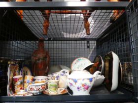 Cage containing carved wooden Chinese figure, various cups and sauces, plus floral patterned china