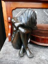 Resin figure of a distraught lady