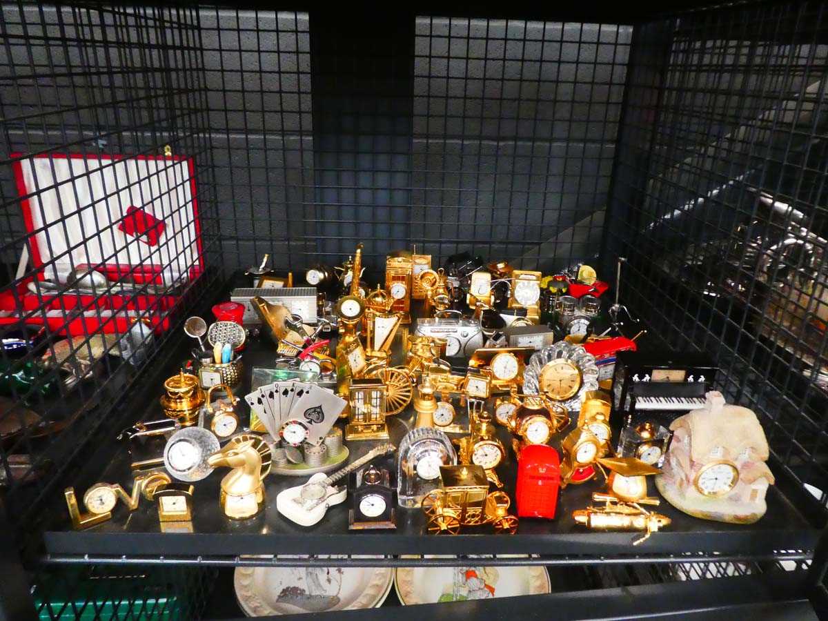 Cage containing collection of miniature quartz clocks