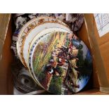 Box containing collectors plates and floral patterned dinner plates