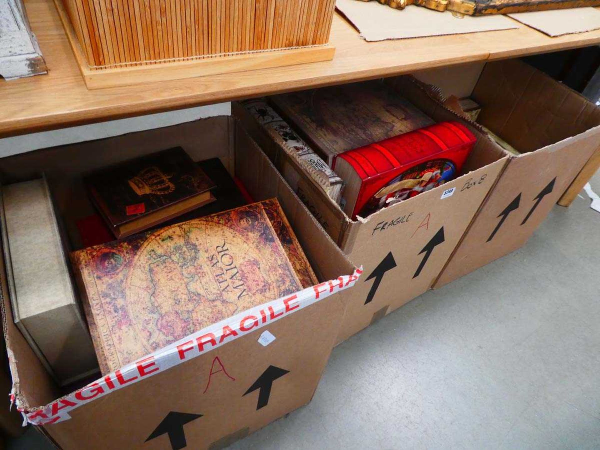 Three boxes containing quantity of playing card, world map and union jack decorated storage boxes