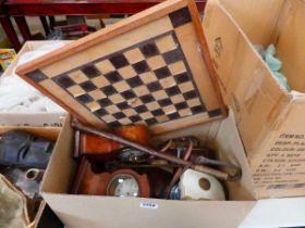 Two boxes containing mantel clocks, chess board, African mask, and camera