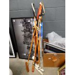 Bundle of polo mallets plus a walking stick