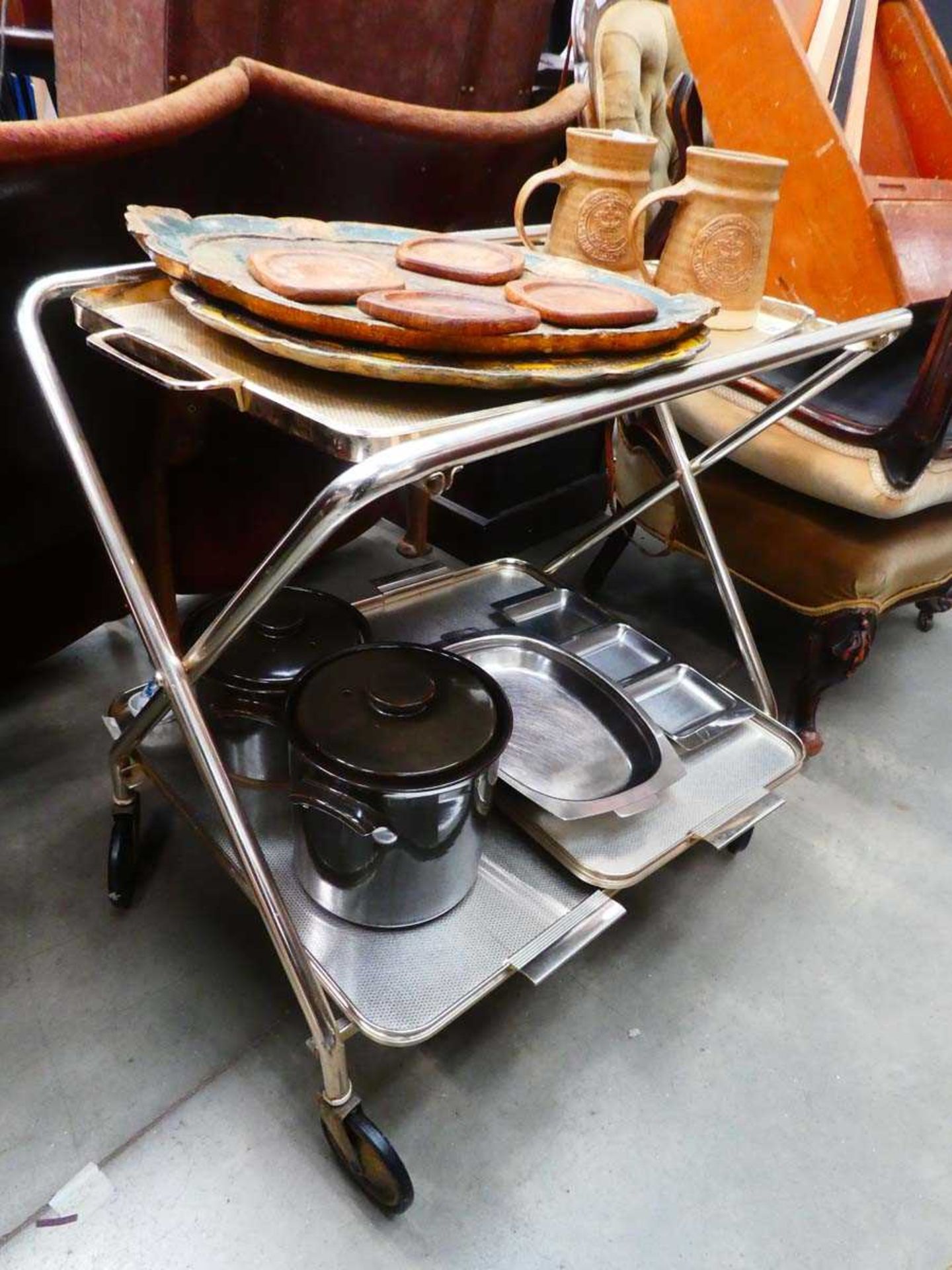 1950's 2 tier tea trolley with a quantity of painted wooden serving trays, coasters plus stainless