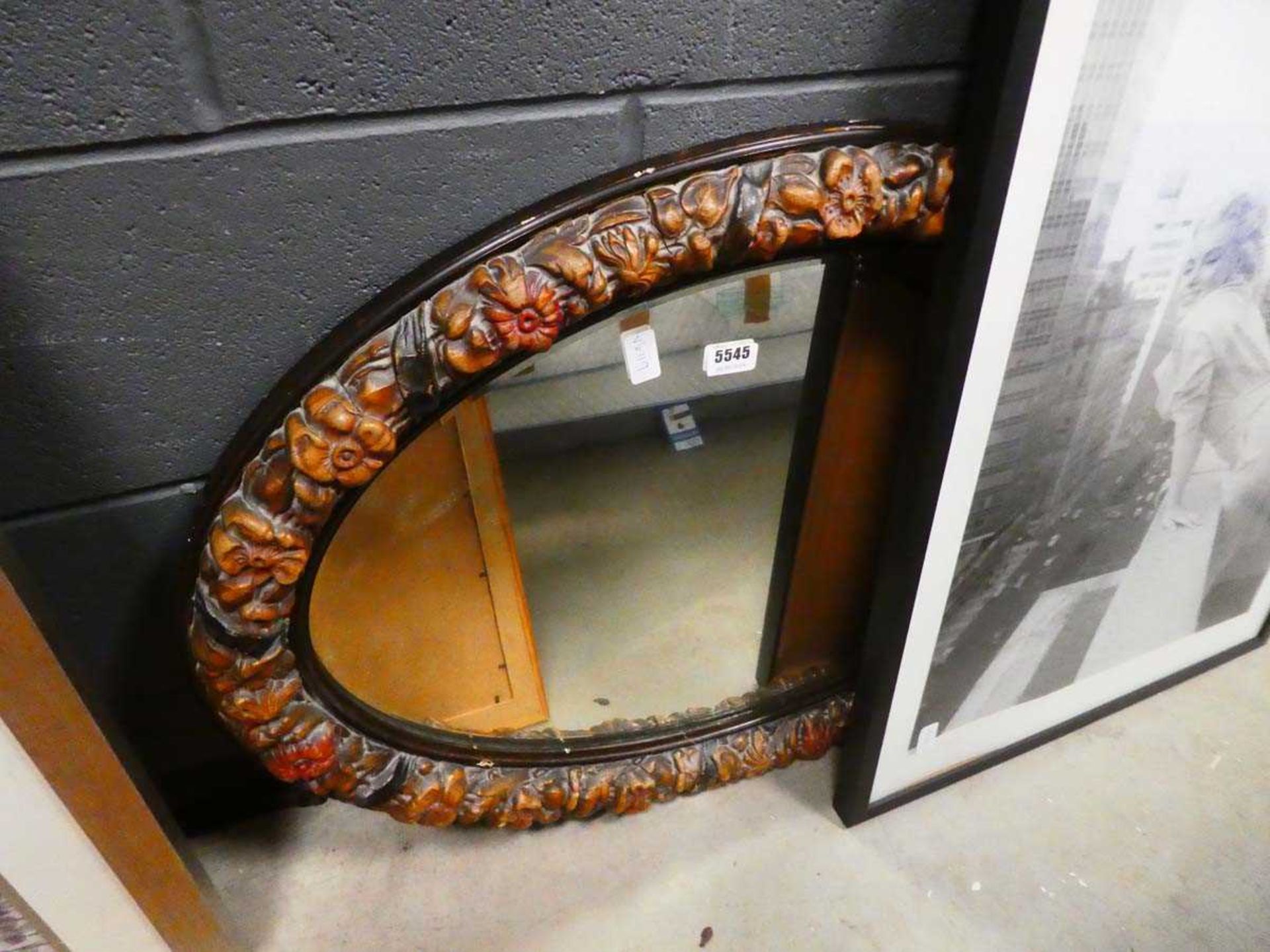 Oval bevelled mirror in floral frame